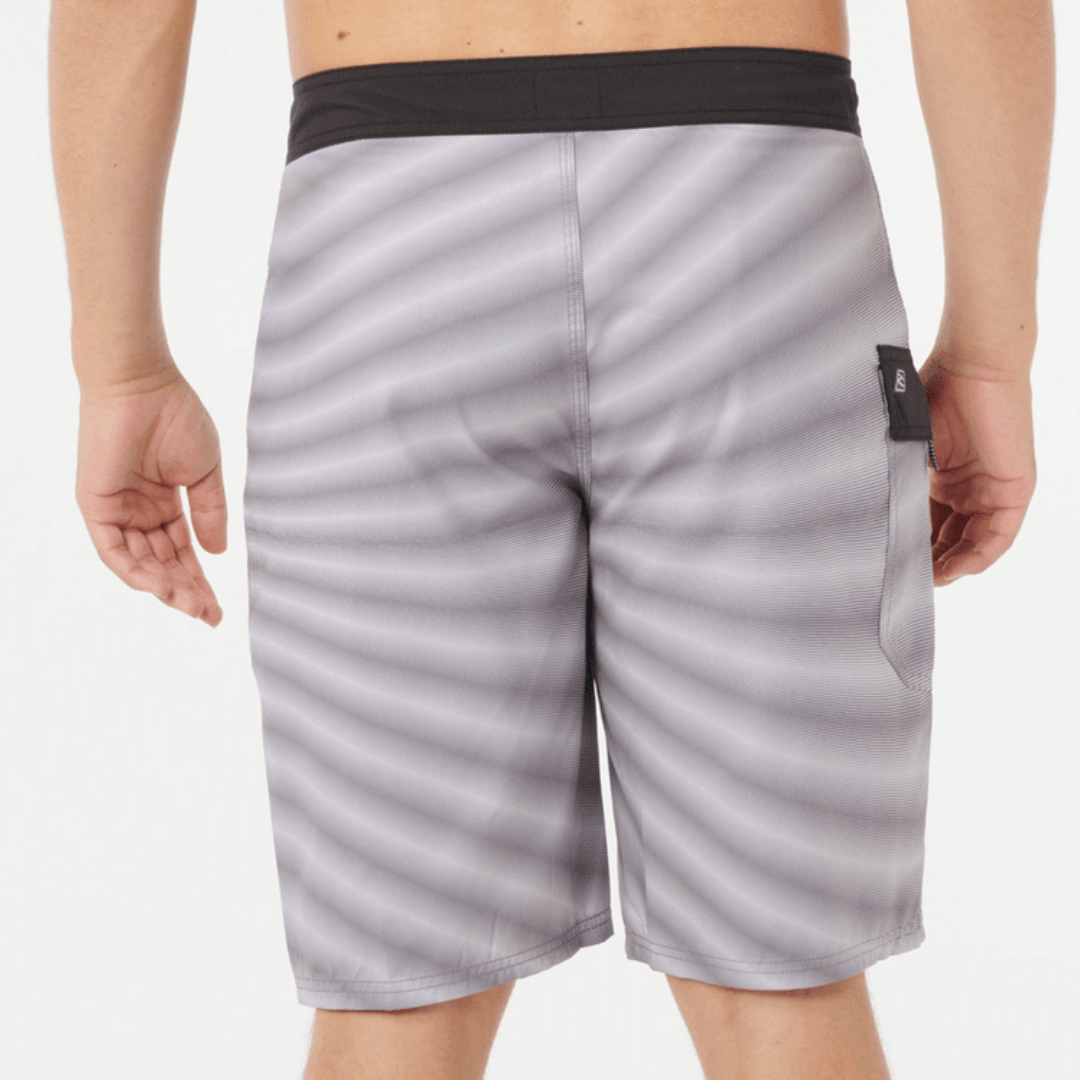 Back View of model wearing Rip Curl Shock Wave Boardshort Cool Grey available at Stewart’s Menswear Mullumbimby. Men’s quick-dry DWR surf shorts with side pocket.