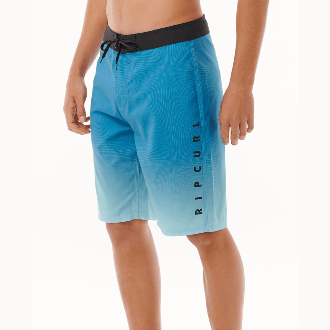 Stewarts Menswear Rip Curl Shock Boardshort. Photo shows side view of model wearing Rip Curl Shock Boardshorts. Colour is Blue.