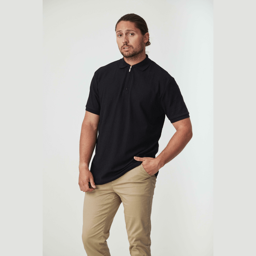 Stewarts Menswear Blackwood apparel Magenta zip polo, colour is black. Photo shows model wearing Blackwood Magenta black zip polo.