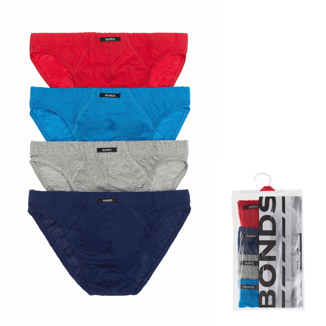 Four pairs of Bonds brand men's briefs in red, blue, gray, and navy, displayed vertically on a white background next to their clear plastic retail packaging. BOnds 4 pack cotton action brief available from Stewart's Menswear, Mullumbimby