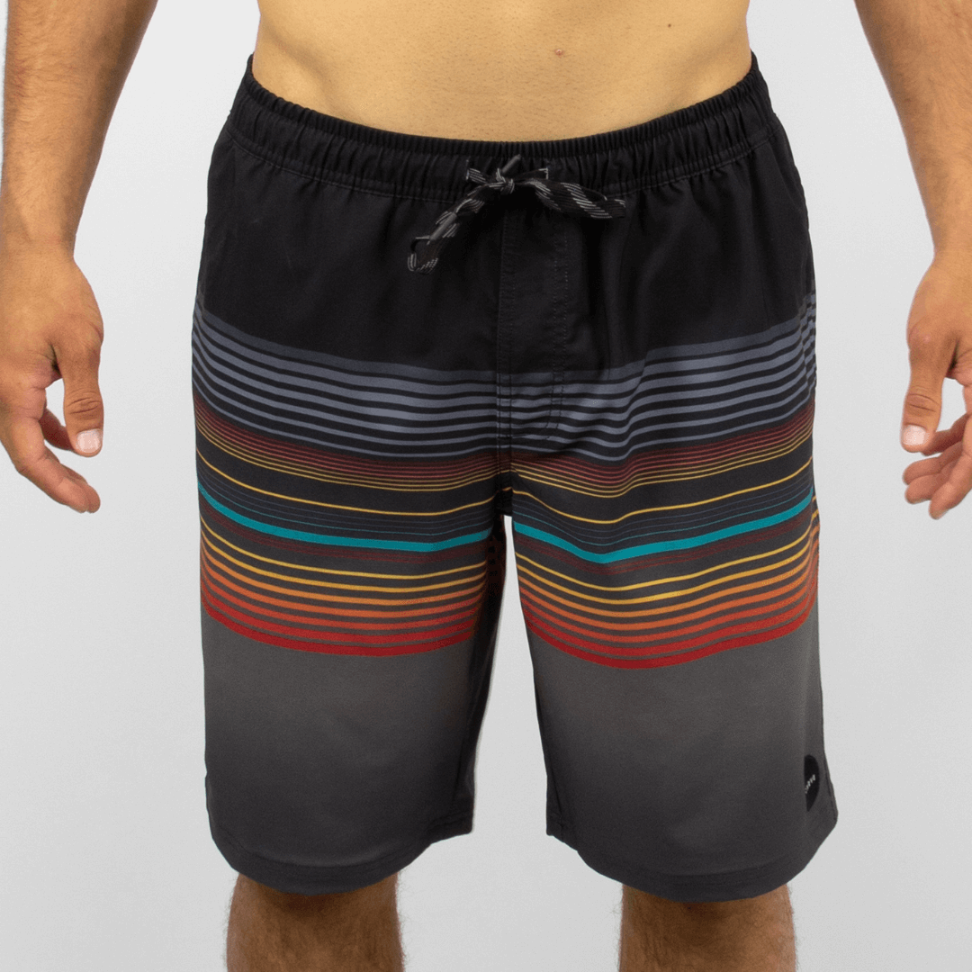 Carve Jan Juc Boardshort available at Stewart’s Menswear Mullumbimby. Men’s elastic waist recycled boardshorts with drawcord and zip pocket. Black base with multi coloured small stripes.