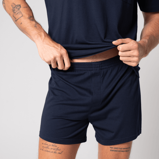 Contare CloudSoft Jersey 2-Pack Boxer Shorts in French Navy and Charcoal Marle, available at Stewart's Menswear Mullumbimby. Model wears Frency Navy.