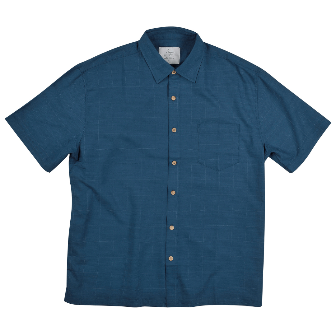 Kingston Grange Bamboo Shirt available at Stewart’s Menswear Mullumbimby. Plain colour short sleeve men’s shirt in bamboo-cotton blend, sustainable and breathable. Colour is Ocean, a rich blue colour.
