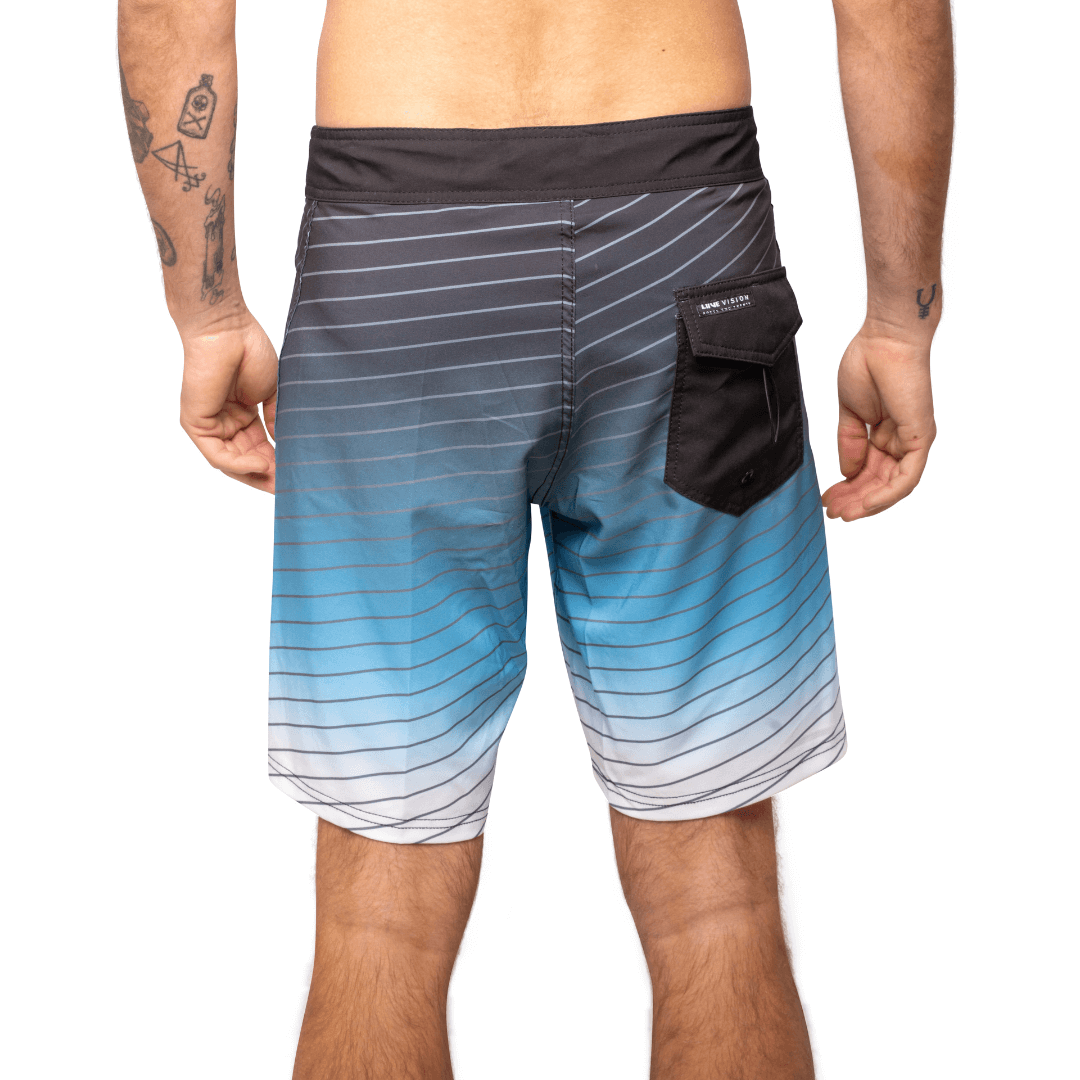 Stewarts Menswear Liive Apparel Cartesian Boardshort. Fitted waist with drawcord, back patch pocket with velcro closure and key loop in the back pocket. Charcoal waistband. Trendy gradient colour design in blue/white shades with charcoal stripe all over. Charcoal back pocket. Front View.