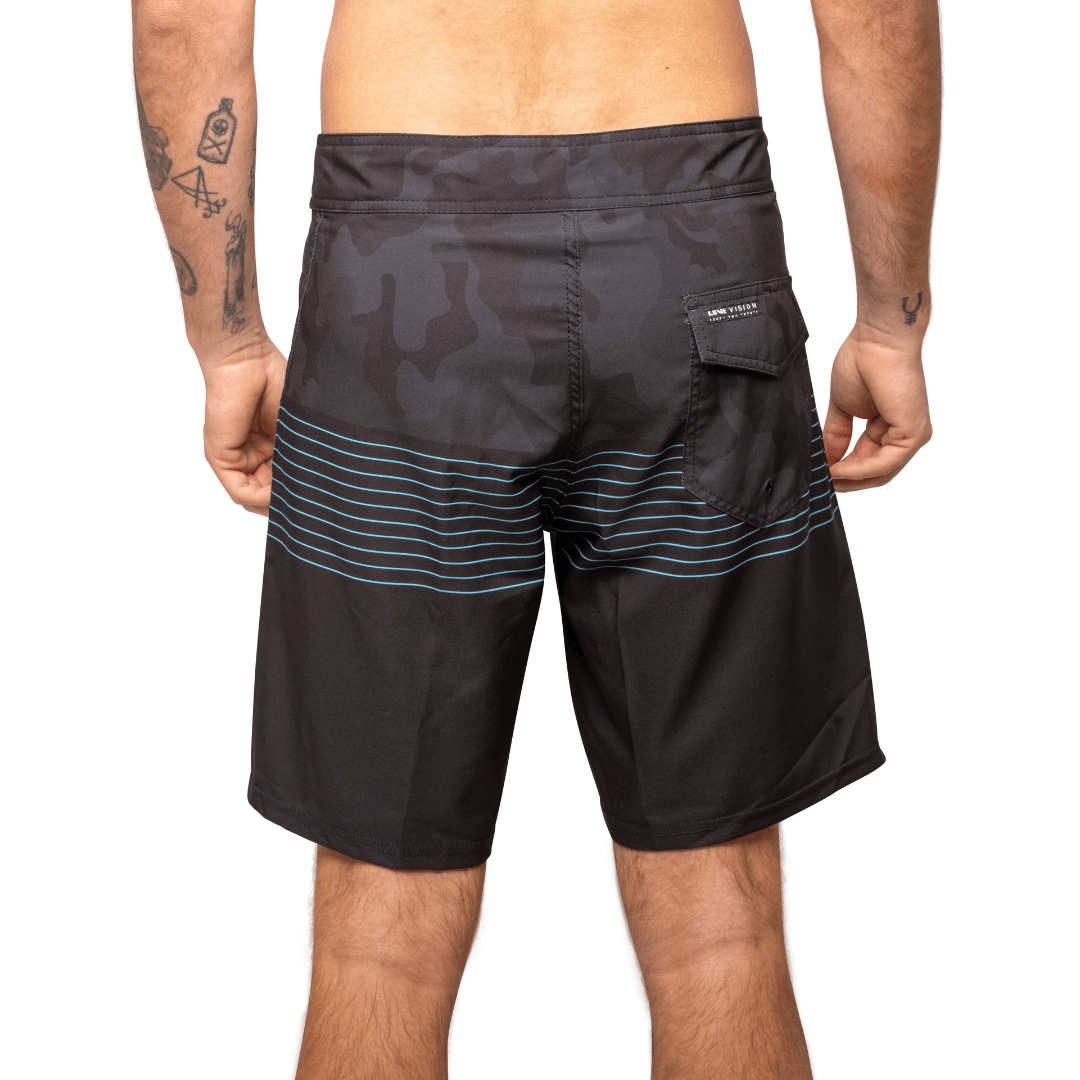 Stewarts Menswear Liive Vision Apparel. Revival Boardshort. Black Camo colour block and top and black colour block at bottom with blue stripes through mid-section. Fitted waist with drawcord, back patch pocket with velcro closure and key loop in the back pocket. Back View.