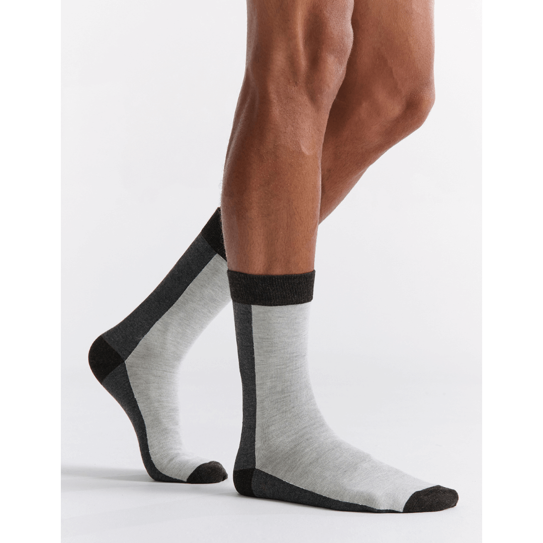 Stewarts Menswear, Mullumbimby. Ambra Bamboo two tone crew socks. Photo shows model wearing Ambra bamboo two tone crew socks. Split colour, back of sock is charcoal, front of sock is light grey with black toe, heel and top trim.