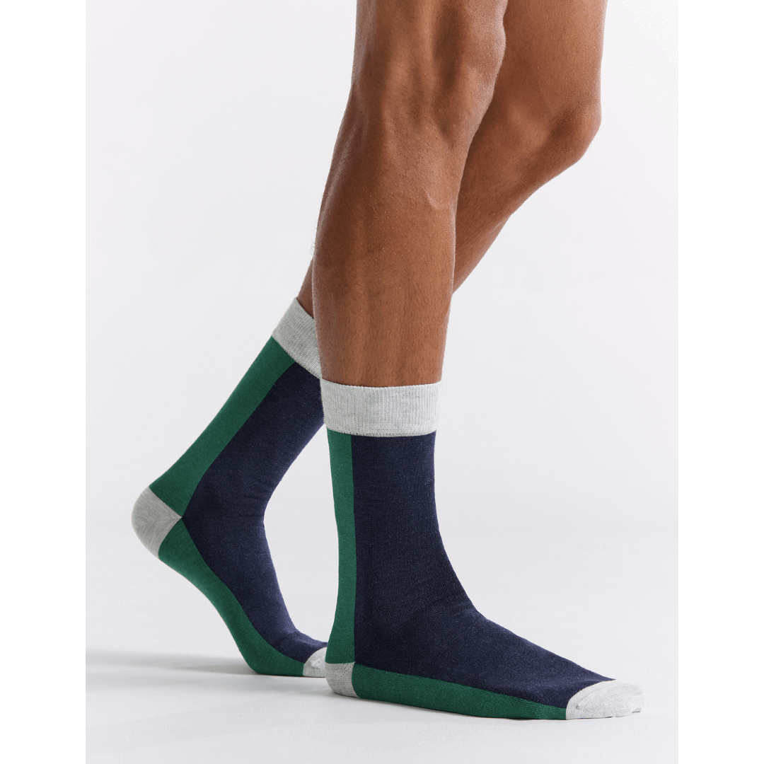 Stewarts Menswear, Mullumbimby. Ambra Bamboo two tone crew socks. Photo shows model wearing Ambra bamboo two tone crew socks. Split colour, back of sock is bottle green, front of sock is navy blue with light grey toe, heel and top trim.