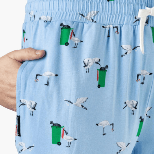 Close up view of Bamboozld men's bamboo sleep pants. Sky blue colour with bin chicken print all over available at Stewart's Menswear, Mullumbimby.