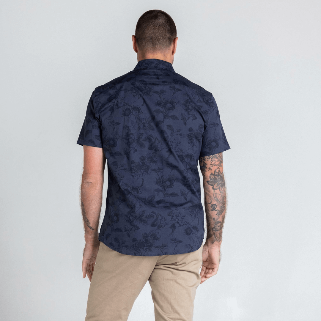 Stewart's Menswear, Mullumbimby. Photo shows model wearing stonleigh short sleeve shirt from Blackwood Apparel. Back View. Colour is charcoal with all over floral print in similar shades.