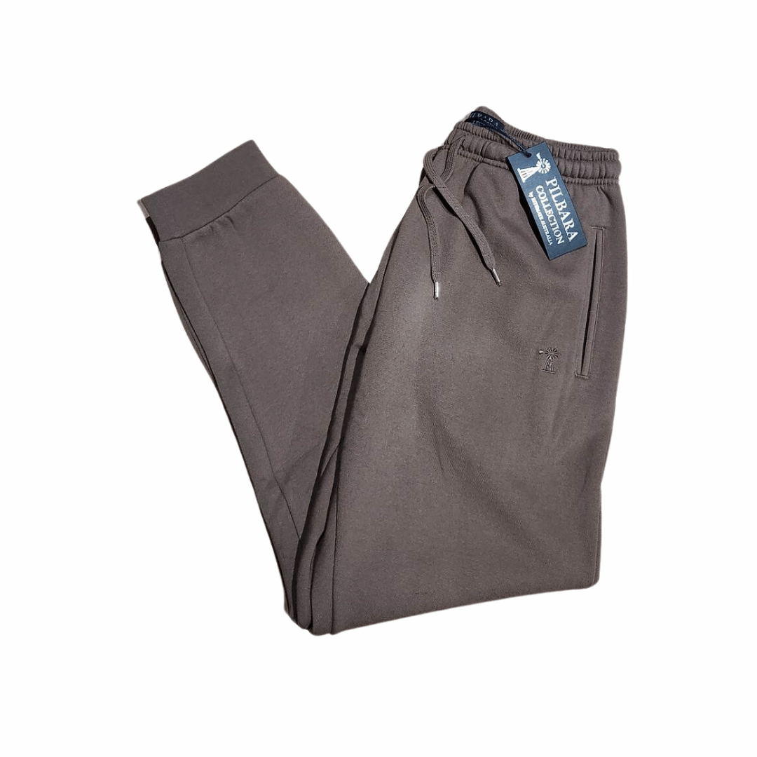 Stewart's Menswear Mullumbimby Pilbara Unisex fleece track pant - Chestnut colour. Made from a blend of 80% cotton and 20% polyester fleece, these track pants provide both warmth and durability, weighing in at a comfortable 310gsm. The track pants feature the Pilbara "Windmill" embroidery and a ribbed cuff. The elastic waistband and waist drawcord ensure a perfect fit for all body types.