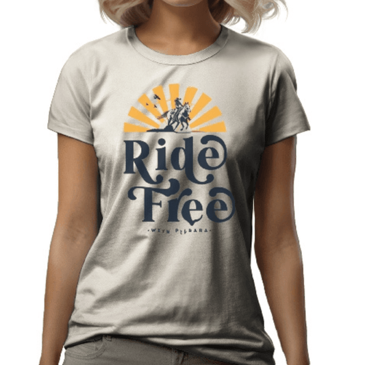 Stewart's Menswear Mullumbimby. Pilbara Western ladies T-shirt. Graphic on front shows woman riding a horse and the text Ride Free With Pilbara Western. Colour is called Scour (a light beige colour)