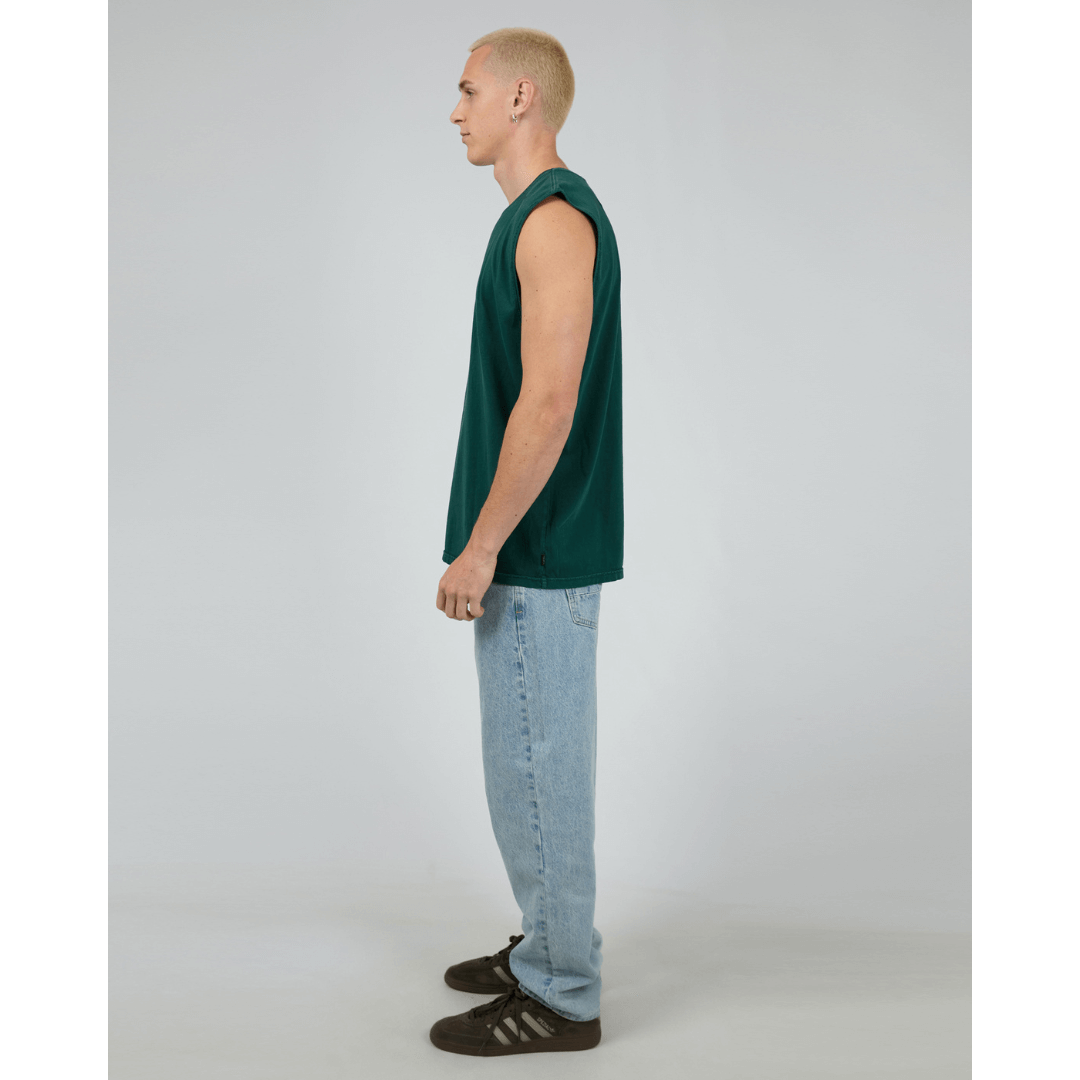 Stewart's Menswear, Mullumbimby. Silent Theory basic classic muscle tee. Photo shows model wearing Pine (Dark Green) coloured Silent Theory Classic muscle, side view.