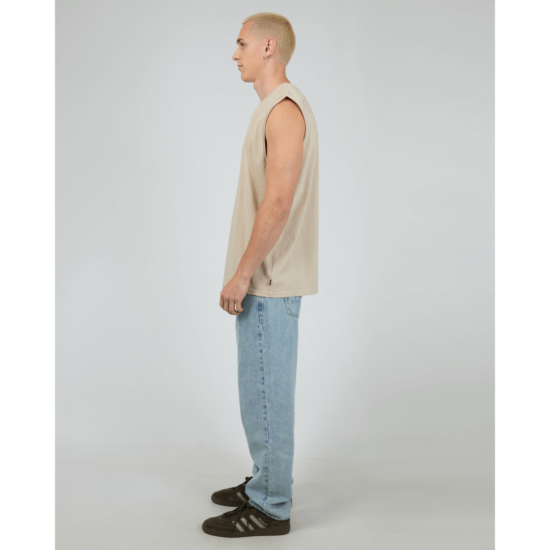 Stewart's Menswear, Mullumbimby. Silent Theory basic classic muscle tee. Photo shows model wearing Tan coloured Silent Theory Classic muscle, side view.