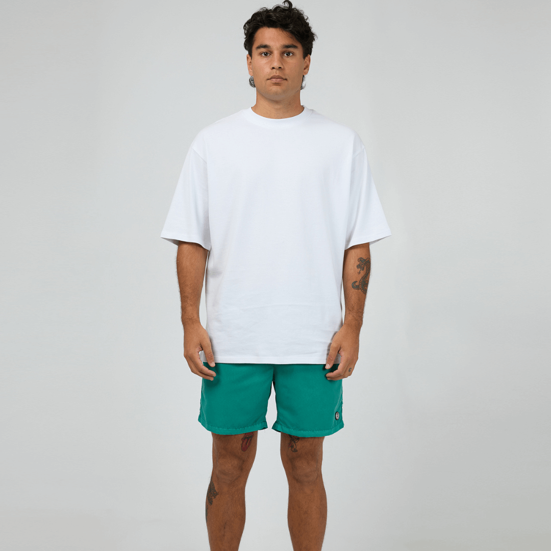 St Goliath Illusion Short available at Stewart's Menswear in Mullumbimby. Photo shows model wearing Tide Green colour St Goliath Illusion Shorts.
