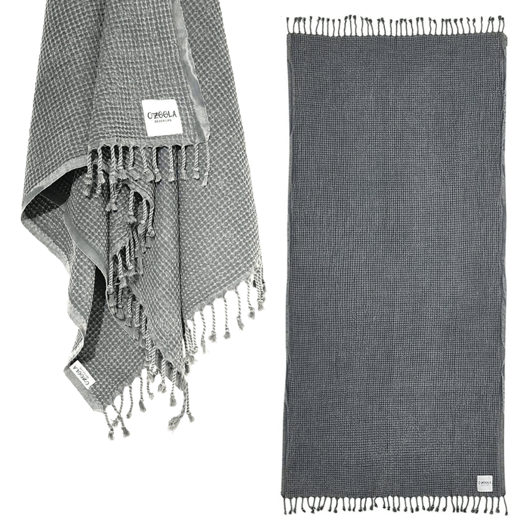 Stewarts Menswear Ozoola Waffle Beach Towel. The Ozoola Waffle Beach Towel is made from 100% Turkish Cotton which is super absorbent and extremely fast drying. Sized at 170 x 185cm with knotted fringing at each end. Colour is Charcoal.