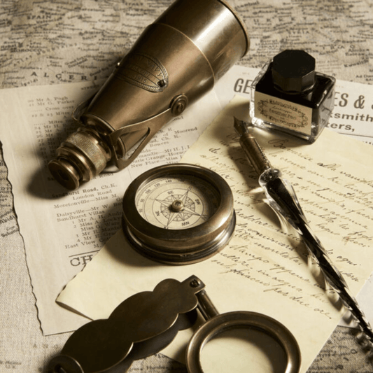 Lifestyle photo of handmade Folding Magnifier in brass and glass with a folding pocket design, available at Stewart's Menswear Mullumbimby.