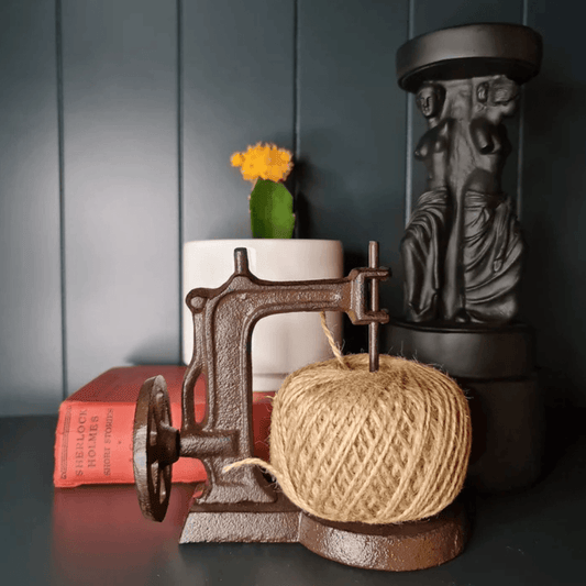 Lifestyle photo of spinning Yarn Dispenser styled as an antique sewing machine, made from iron, available at Stewart's Menswear Mullumbimby.