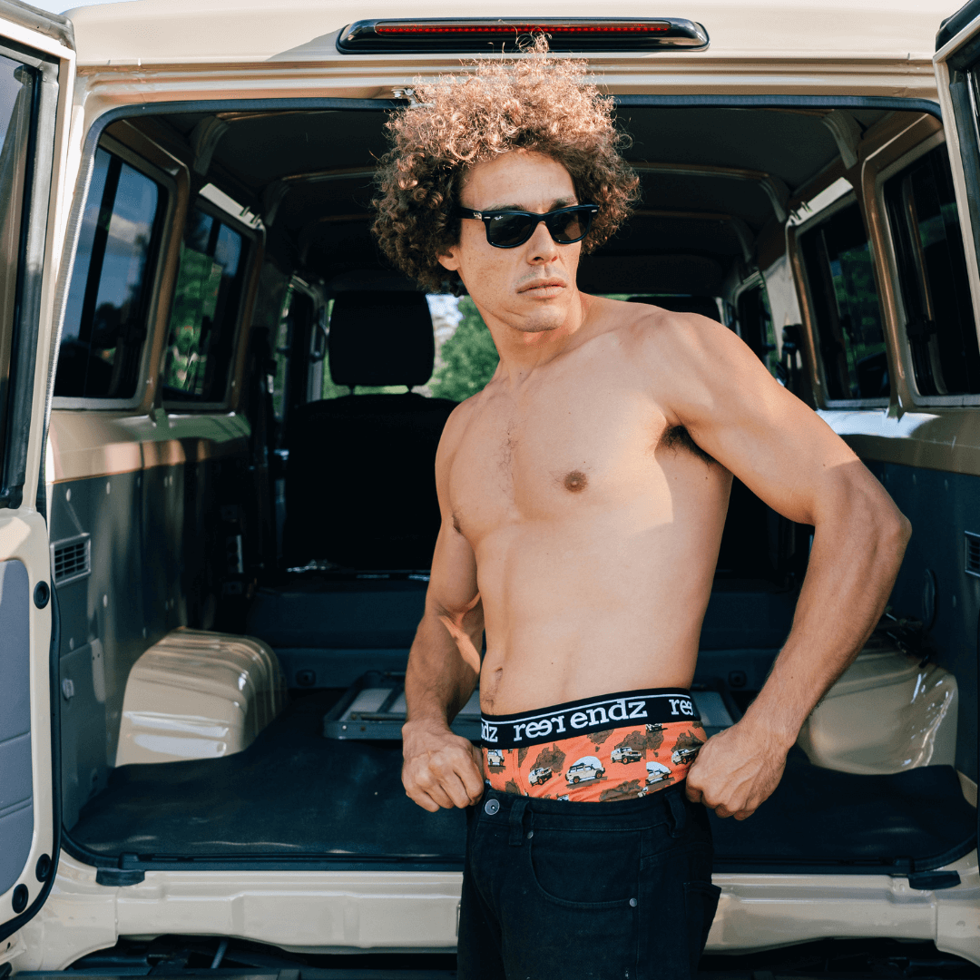 Stewarts Menswear Reer Endz organic cotton underwear. Photo is lifestyle shot of model wearing Reer Endz Cruisin underwear standing behind a vehicle with open doors.