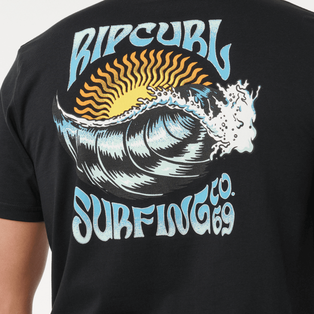 Rip Curl Hazed & Tubed T-Shirt. Black relaxed-fit cotton tee with front and back surf prints, available at Stewart’s Menswear Mullumbimby. Photo shows model wearing Rip Curl Hazed and Tubed Tee, close view