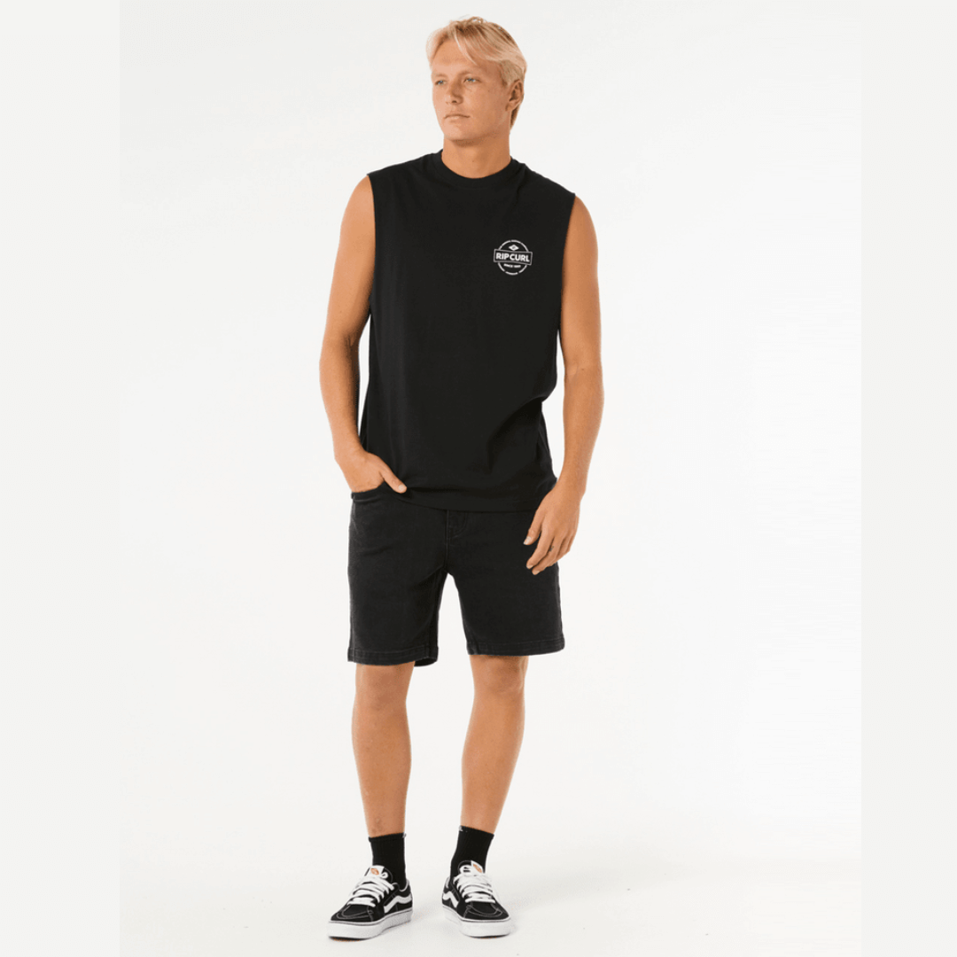 Stewarts Menswear, Mullumbimby. Rip Curl Stapler Muscle Tee. Colour is black. Small Rip Curl logo on front and larger logo on back. Photo shows model wearing Rip Curl Stapler Muscle Tee, front view.