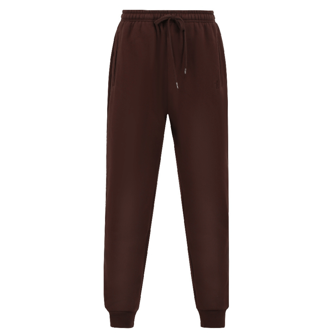 Stewart's Menswear Mullumbimby Pilbara Unisex fleece track pant - Coffee Bean colour. Made from a blend of 80% cotton and 20% polyester fleece, these track pants provide both warmth and durability, weighing in at a comfortable 310gsm.   The track pants feature the Pilbara "Windmill" embroidery and a ribbed cuff. The elastic waistband and waist drawcord ensure a perfect  fit for all body types.
