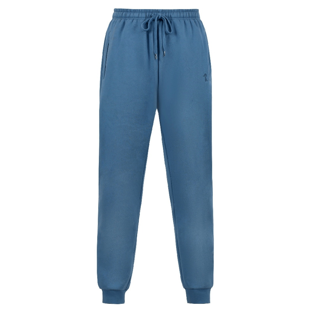 Stewart's Menswear Mullumbimby Pilbara Unisex fleece track pant - Bluestone colour. Made from a blend of 80% cotton and 20% polyester fleece, these track pants provide both warmth and durability, weighing in at a comfortable 310gsm. The track pants feature the Pilbara "Windmill" embroidery and a ribbed cuff. The elastic waistband and waist drawcord ensure a perfect fit for all body types.