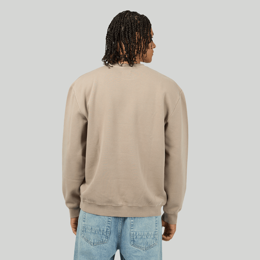 Back view of man wearing a beige sweatshirt against a plain background. Silent Theory Box Crew fleece sweatshirt available at Stewart’s Menswear Mullumbimby.