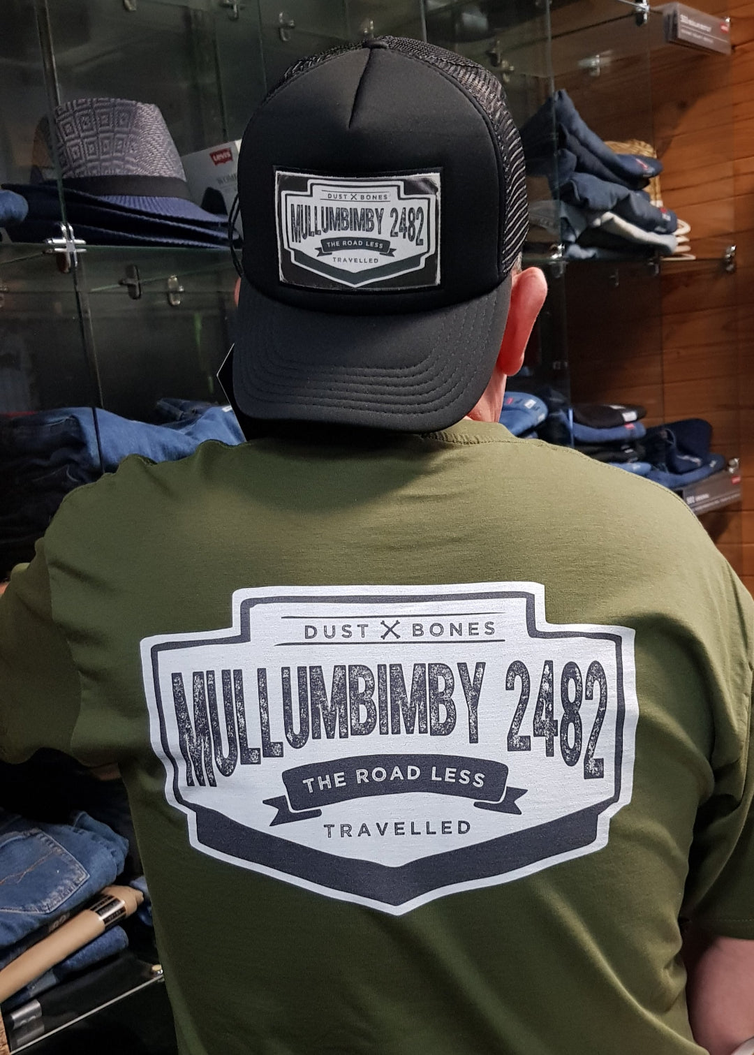 Back view of Gerard wearing Mullumbimby souvenir T-shirt with matching Mullumbimby Souvenir cap