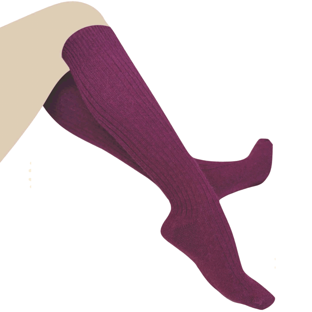Stewarts Menswear Humphrey Law Australian made alpaca/wool blend knee-hi socks. An exceptionally warm luxury knee-high sock made with a blend of alpaca and wool. Alpaca fibre is soft, supple and smooth and contains microscopic air pockets which act as insulators keeping in the warmth provided by the wool. Please note as alpaca is a luxury fibre these socks are not recommended for high abrasion use such as work boots. This is a lifestyle photo of model wearing Berry colour, a rich crimson colour.