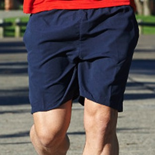 Stewarts Menswear Microfibre shorts. Made from 100% polyester with no lining, these shorts are designed for the active man. The fabric is lightweight and soft, perfect for everyday wear. Lifestyle photo of man wearing navy coloured microfibre shorts.