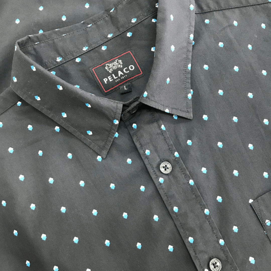 Pelaco men's short sleeve shirt. Navy colour with white/aqua geometric print all over. Close up photo of shirt.