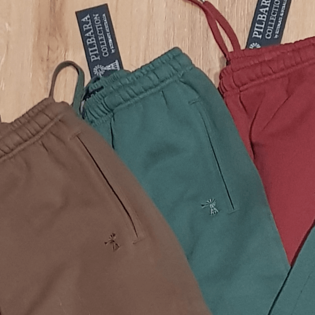 Stewart's Menswear Pilbara Collection modern fit fleece track pants.Made from a blend of 80% cotton and 20% polyester fleece, these track pants provide both warmth and durability, weighing in at a comfortable 310gsm. The track pants feature the Pilbara "Windmill" embroidery and a ribbed cuff. The elastic waistband and waist drawcord ensure a perfect fit for all body types. An image showing 3 pants in colours - Bourbon & Tobacco have limited stock available.