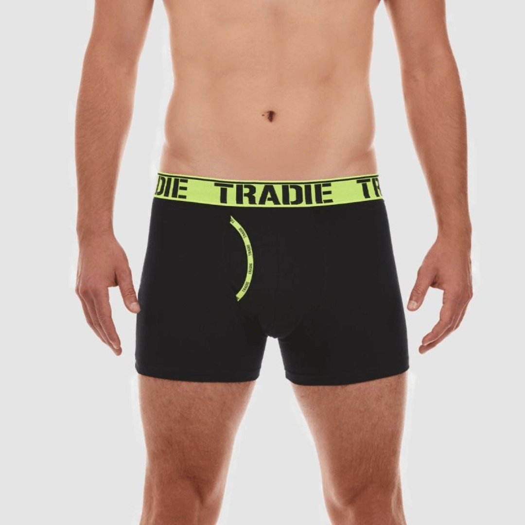Stewart's Menswear Tradie man front trunk. Tradie Man Front Trunk is made from a blend of cotton and elastane, great for everyday wear.  The soft jacquard elastic waistband ensures a comfortable fit, while the working fly provides easy access.  The stretch cotton fabric is durable and designed to move with you. Model is wearing black trunks with fluoro yellow waistband and fly front trim.