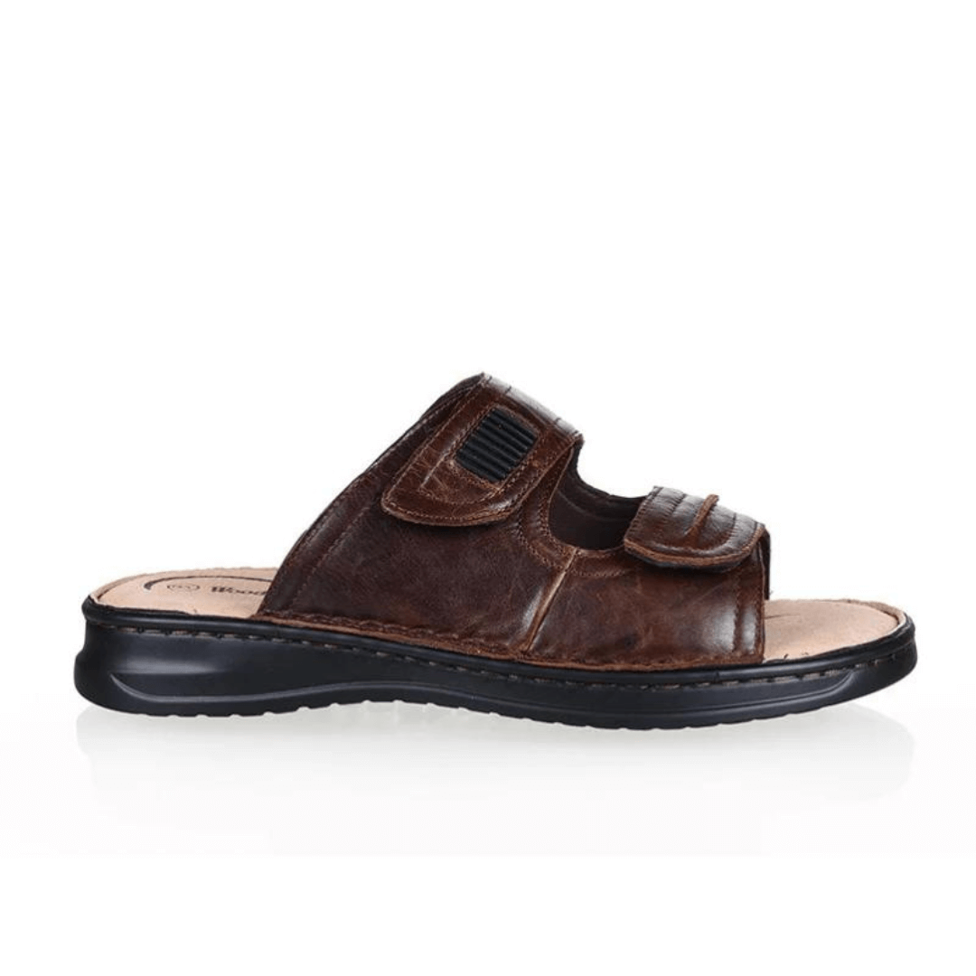 Stewart's Menswear Woodlands Gerard Leather slide. Gerard leather slides by Woodlands are the perfect everyday leather slide for men. With adjustable straps, they fit any foot. Whether you have a narrow or wide foot, you can easily adjust the straps to ensure a perfect fit. Features a leather upper and lining plus the padded insole will keep your feet feeling comfortable all day long. Side view