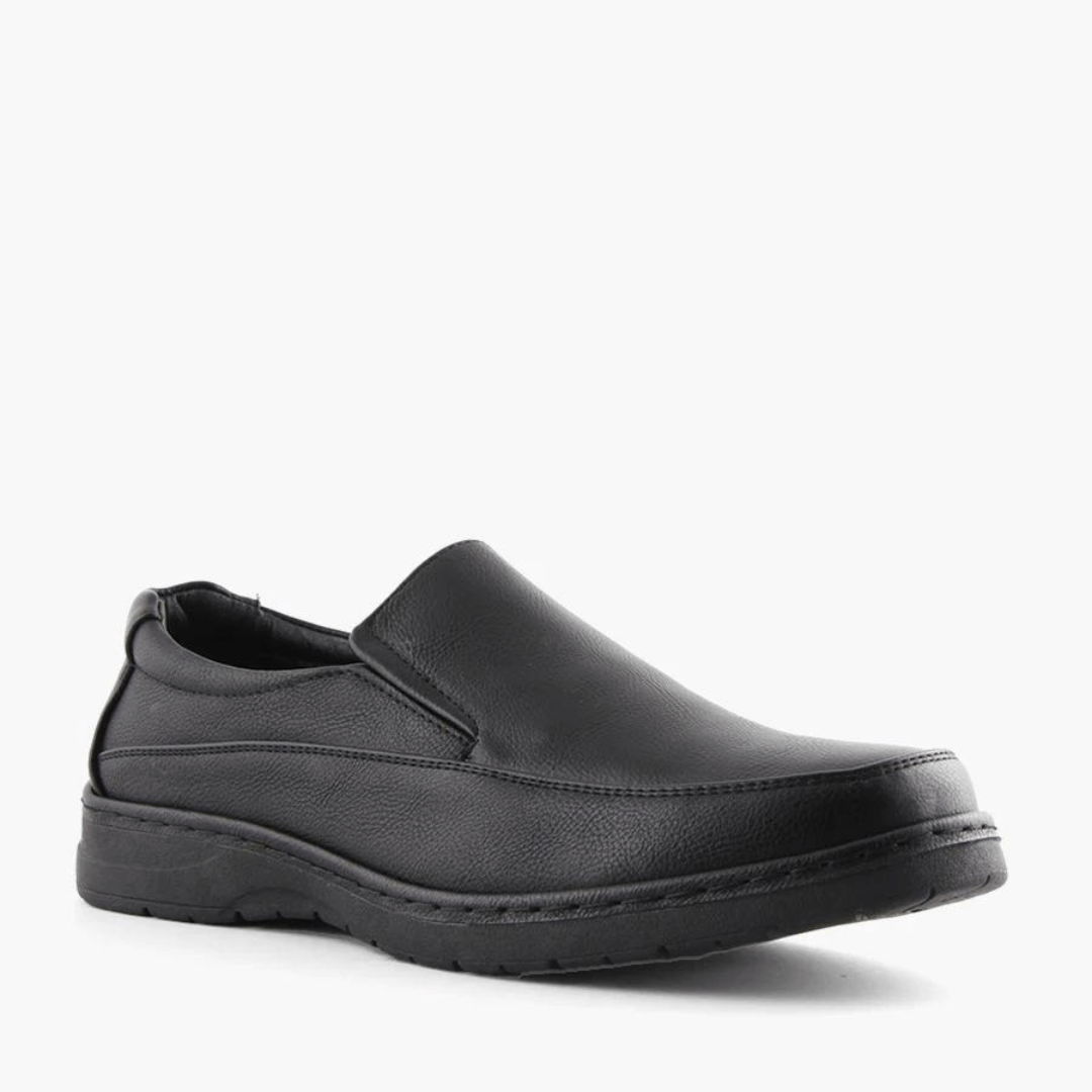 Stewart's Menswear Woodlands Shortall men's slip on shoe.Shortall by Woodlands is a men's slip-on shoe which features a rounded toe silhouette. It has an arched low rubber outsole and heel support plus a full insole cushioned foot bed. Man-made upper, lining and sole. Front view, Colour is black.