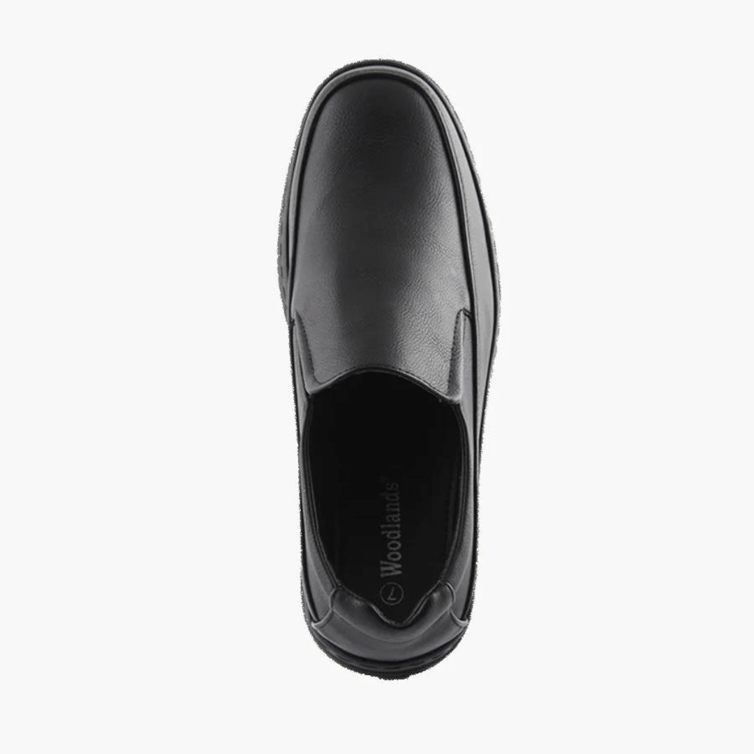 Stewart's Menswear Woodlands Shortall men's slip on shoe.Shortall by Woodlands is a men's slip-on shoe which features a rounded toe silhouette. It has an arched low rubber outsole and heel support plus a full insole cushioned foot bed. Man-made upper, lining and sole. Top view, Colour is black.