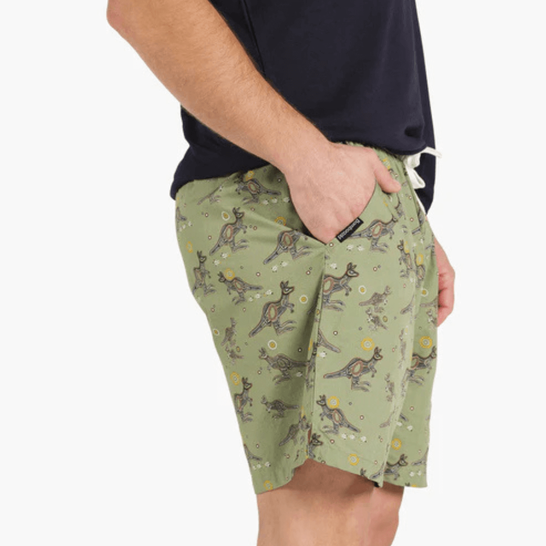 Stewart's menswear, Mullumbimby. Bamboozld Bamboo Sleep Short. Colour is khaki with all over indigenous kangaroo print. Photo shows model wearing sleep shorts, side view.