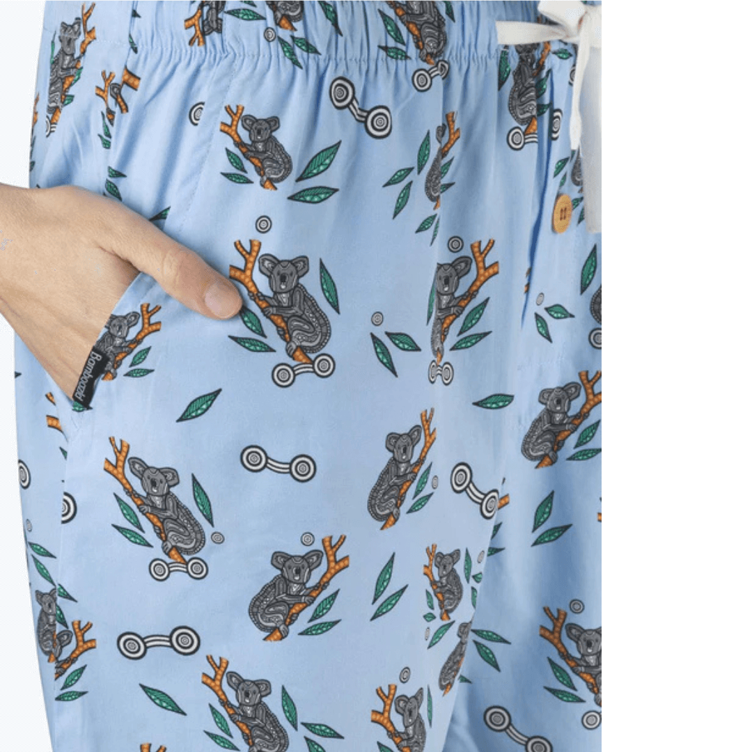 Stewart's Menswear, Mullumbimby. Bamboozled Bamboo Sleep shorts. Photo shows side view of model wearing Bamboozld Bamboo Sleep Shorts. Colour is sky blue with all over indigenous Koala print.