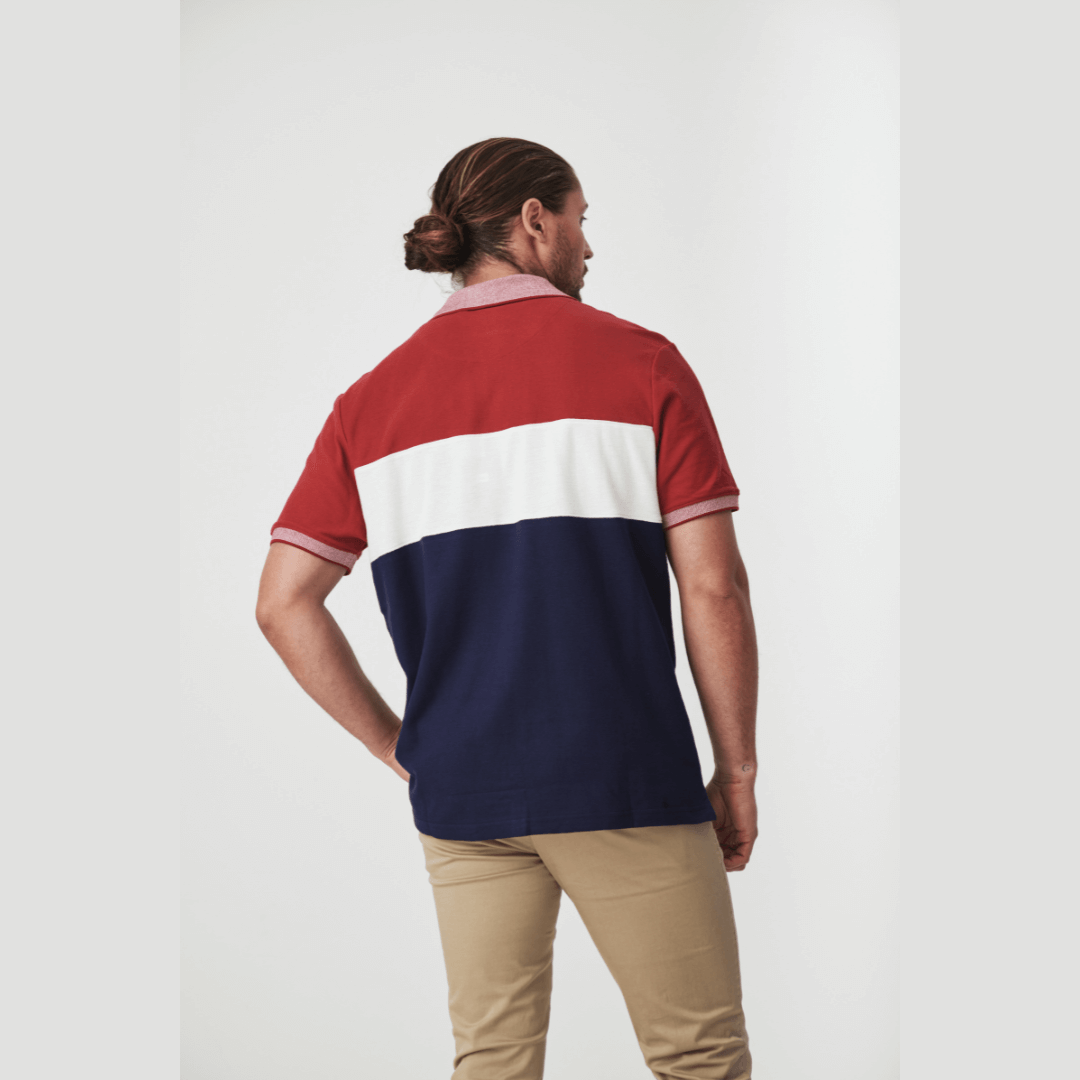 Stewarts Menswear Blackwood Apparel Bronte Polo Shirt. The Blackwood Apparel Bronte Short Sleeve Polo is made from 100% cotton. Its colour block design in navy, burgundy, and white gives it a casual sophistication.  Photo shows full length photo of model wearing Bronte Polo shirt, back view.