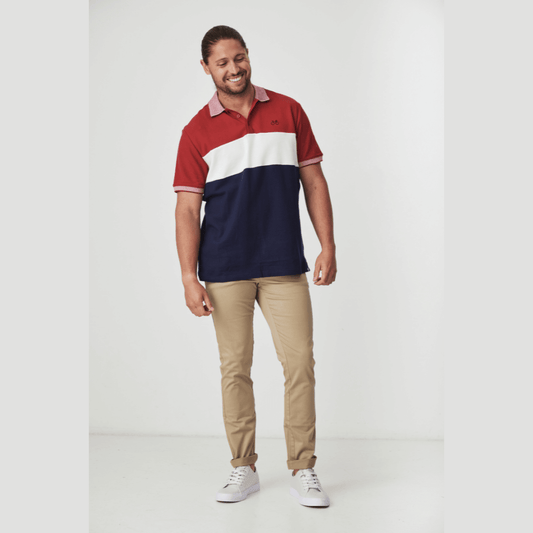 Stewarts Menswear Blackwood Apparel Bronte Polo Shirt. The Blackwood Apparel Bronte Short Sleeve Polo is made from 100% cotton. Its colour block design in navy, burgundy, and white gives it a casual sophistication.  Photo shows full length photo of model wearing Bronte Polo shirt.