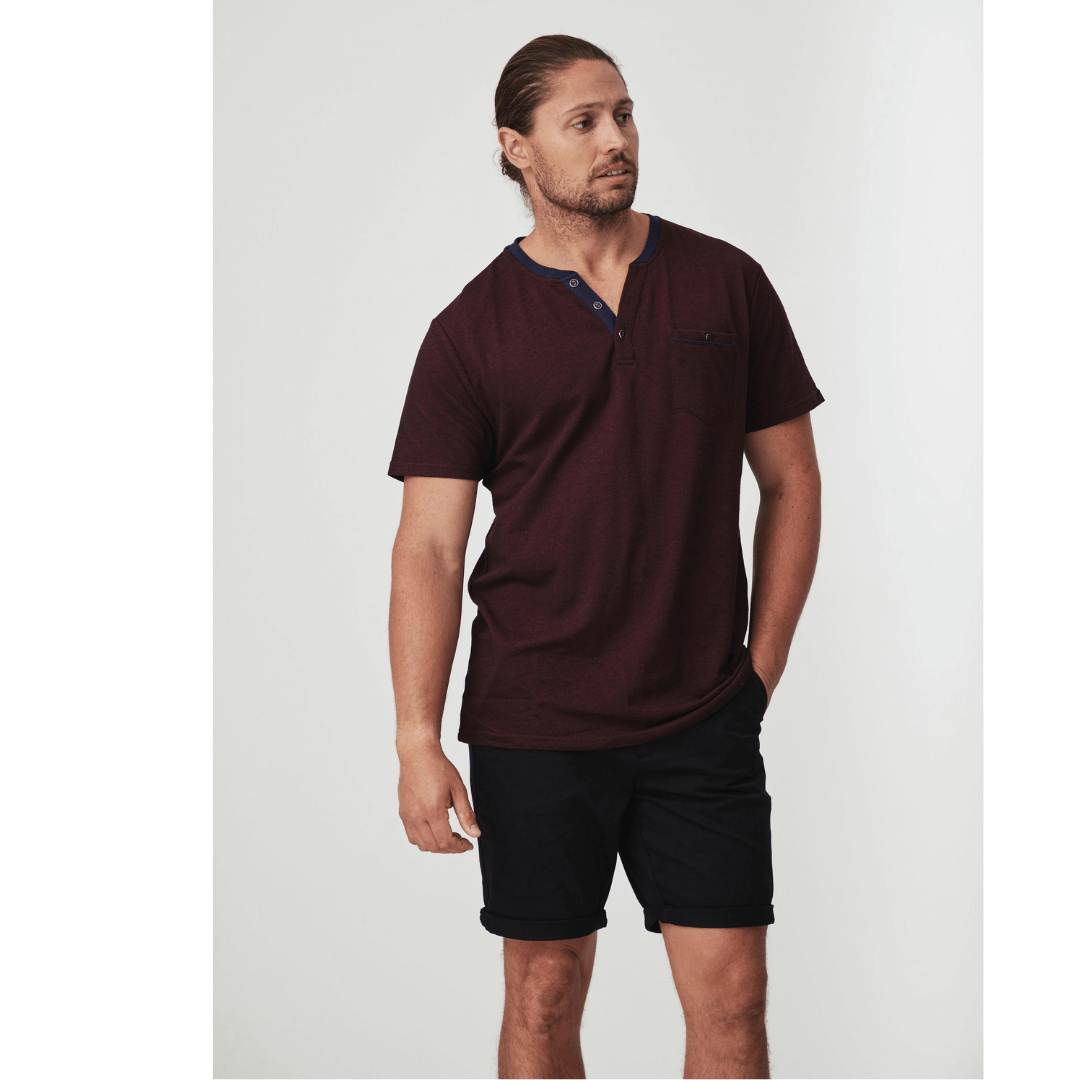 Stewart's Menswear Blackwood Apparel Fox Henley Tee. Round neck featuring a buttoned half-placket fastening for an authentic Henley look. Colour is Burgundy. Photo shows model wearing Blackwood Fox Henley Tee front view.