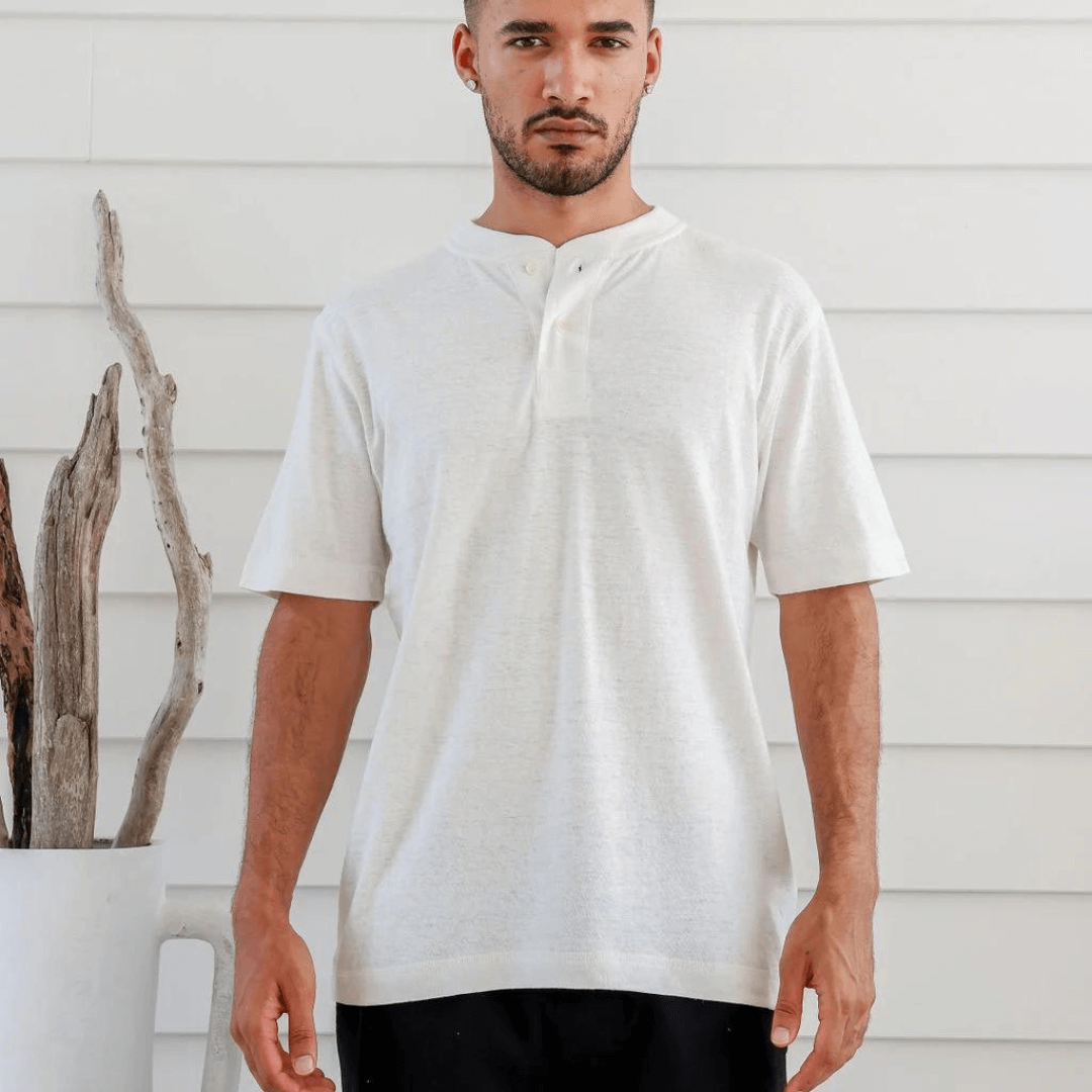 Stewarts Menswear Braintree Hemp. Hemp/Cotton button t-shirt. Hemp/Cotton short sleeve button tee is made from 55% Hemp and 45% Cotton and features a wide placket with two buttons. Photo shows model wearing natural coloured shirt - front view.