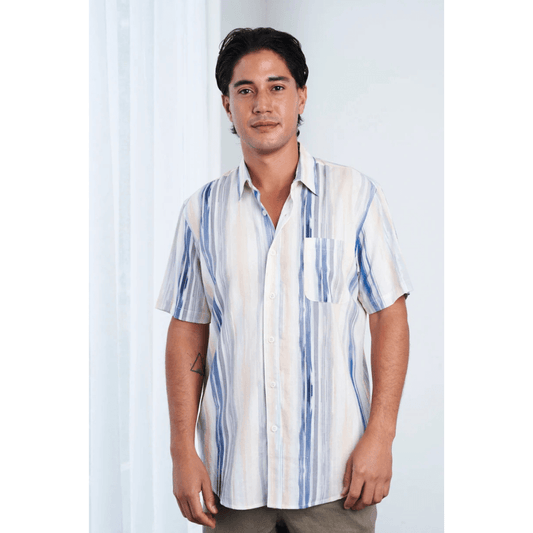 Front view of model wearing men’s Hemp Rayon Waterfall Short Sleeve Shirt – Blue Peach. Soft hemp-rayon blend, available at Stewart’s Menswear Mullumbimby. White shirt with blue and peach coloured waterfall type stripes running downwards.