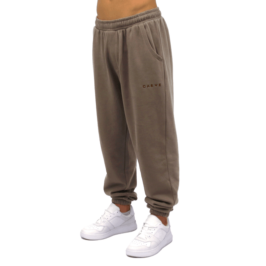 Front view of Carve Bowen Track Pant in driftwood available at Stewart’s Menswear Mullumbimby. Regular fit track pants with elastic waist, ankle cuffs and angled pockets.