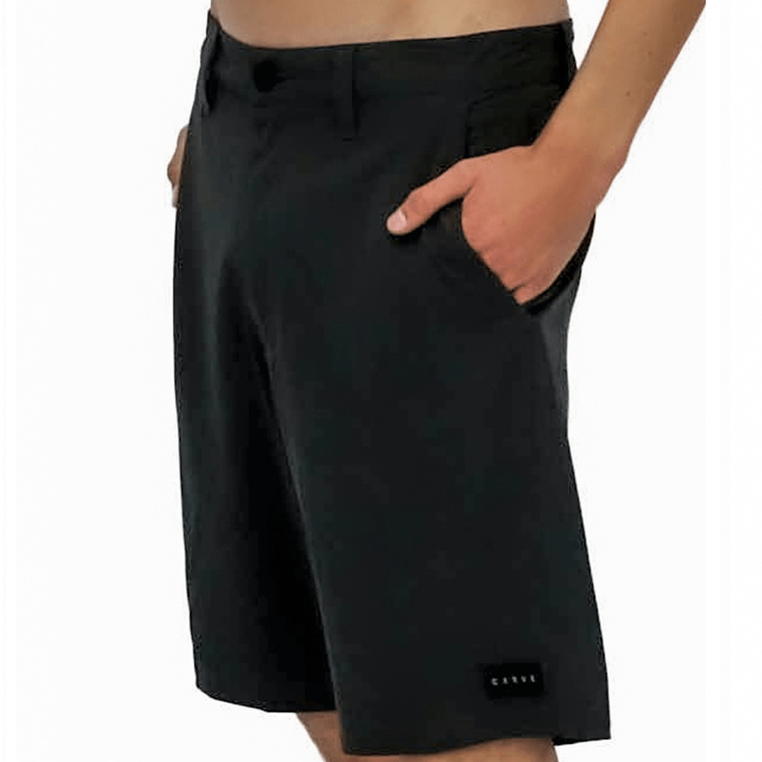 Carve Pelagic Walk Short in black, men's quick dry stretch hybrid shorts with side pockets and Carve logo badge on the leg, available at Stewart's Menswear Mullumbimby.