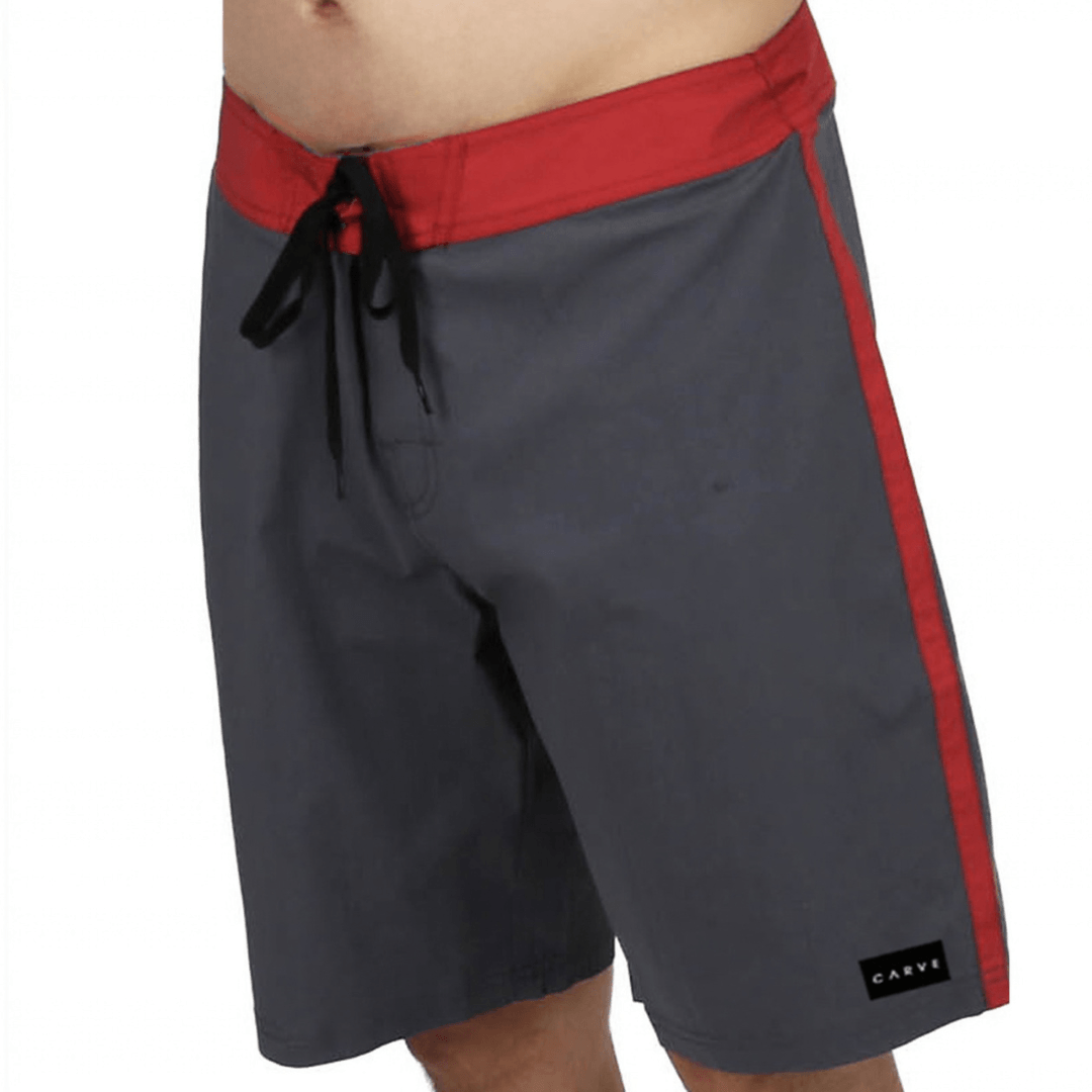 Carve Surfbreak Boardshorts in charcoal with red waistband, red side stripe and Carve logo badge, available at Stewart's Menswear Mullumbimby.