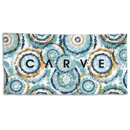 Stewarts Menswear Carve surfwear Hula beach towel. Made from 100% cotton with velour one side, this beach towel has superior absorbency and comfort.  All over circular print in light and dark blue shades with gold. Similar to a tie-dye look.  No matter if you don't live near the beach, you can also use it for picnics or outdoor concerts.  Size: 85cm x 160cm