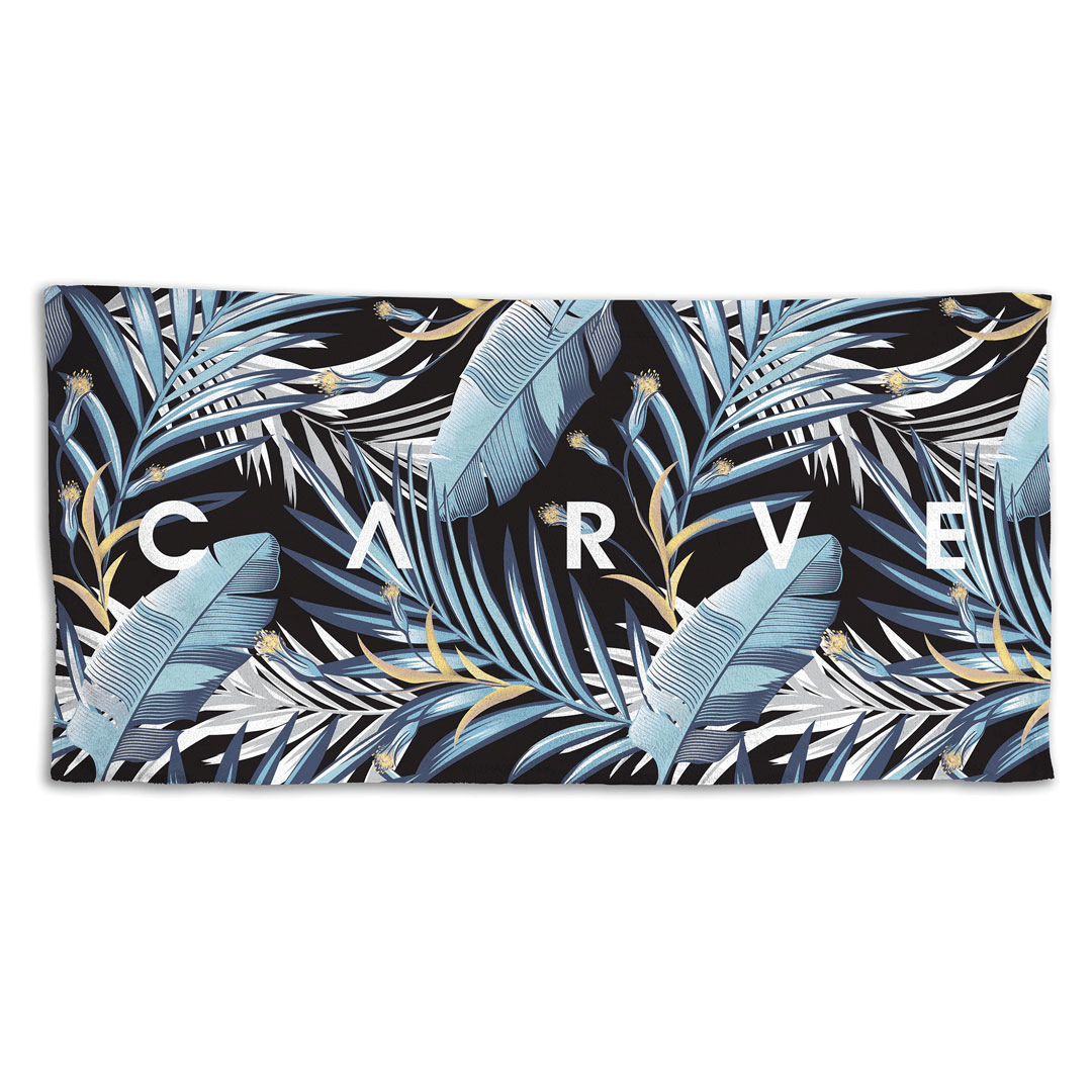 Stewarts Menswear Carve Surfwear Under The Palms Beach Towel. Made from 100% cotton with velour one side, this beach towel has superior absorbency and comfort.  All over palm tree and feather print in dark and light blue shades.