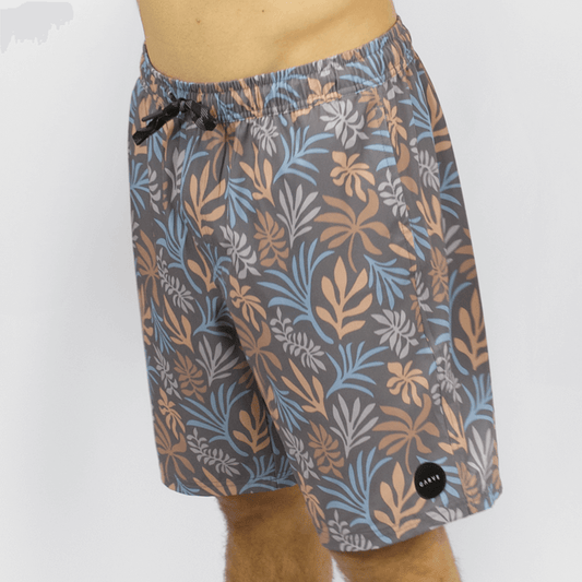 Carve Tully Boardshort  available at Stewart’s Menswear Mullumbimby. Elastic waist boardshort with drawcord, side pockets, and back velcro pocket. Charcoal background with floral print all over.