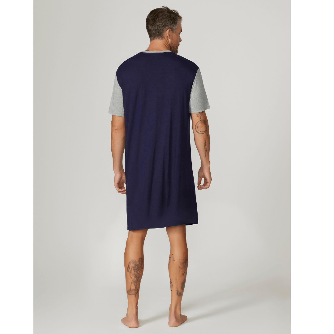 Stewarts Menswear Contare Country Men's nightshirt. Bamboo cotton short sleeve nightshirt. Colour is navy with great sleeves and neck trim. Photo shows model wearing Contare Bamboo Cotton Short Sleeve Nightshirt, back view.